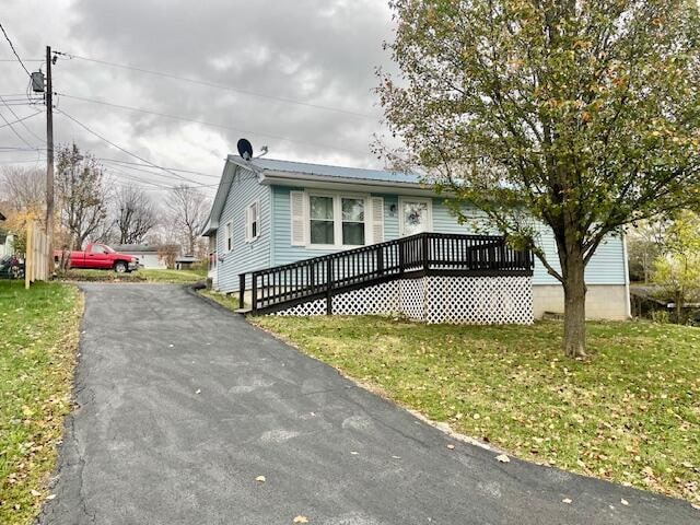 view of front of house featuring a front yard and a wooden deck