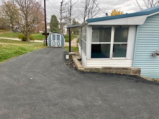 view of side of property featuring a storage unit