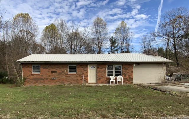 rear view of property with a lawn