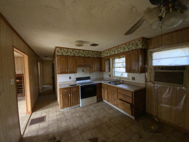 kitchen with a textured ceiling, cooling unit, sink, and white stove