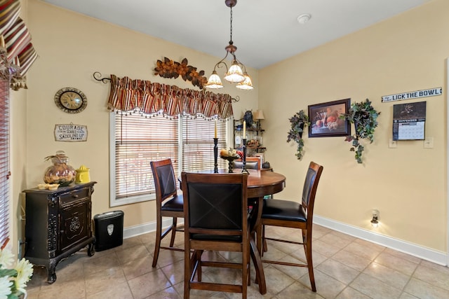 dining room with a notable chandelier and light tile patterned flooring