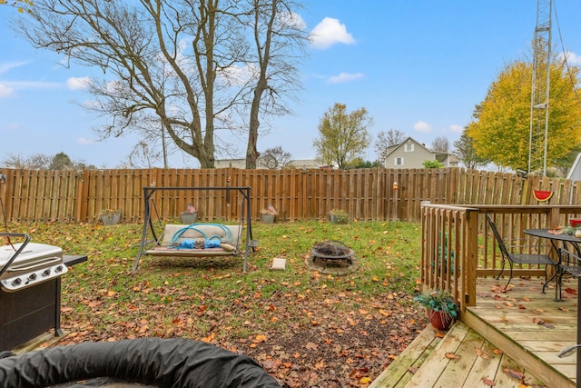 view of yard with a fire pit and a deck