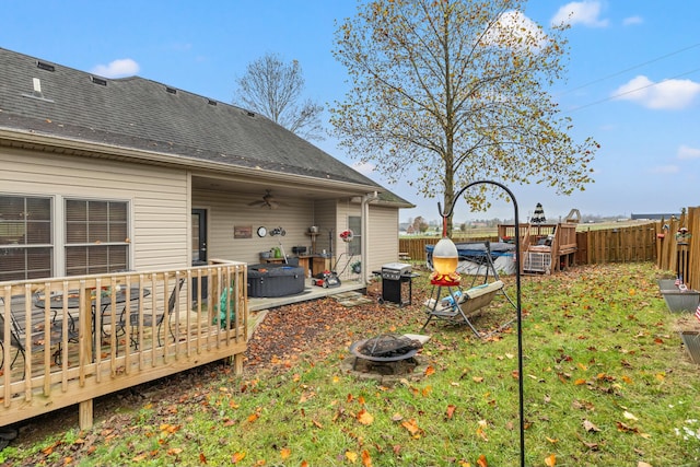 view of yard with a fire pit and a pool side deck