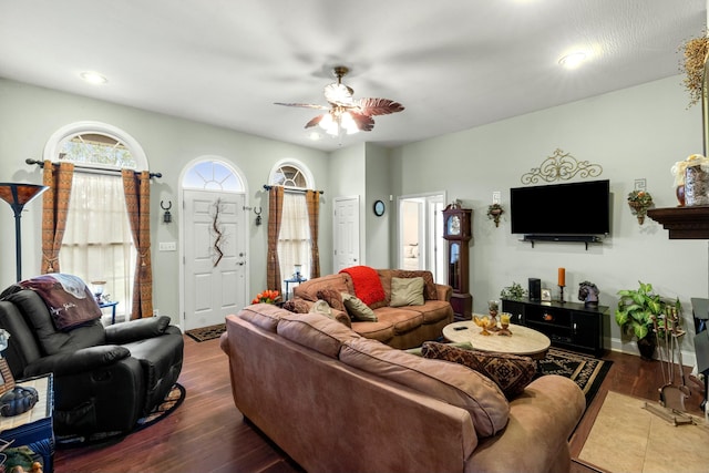 living room with dark hardwood / wood-style floors and ceiling fan