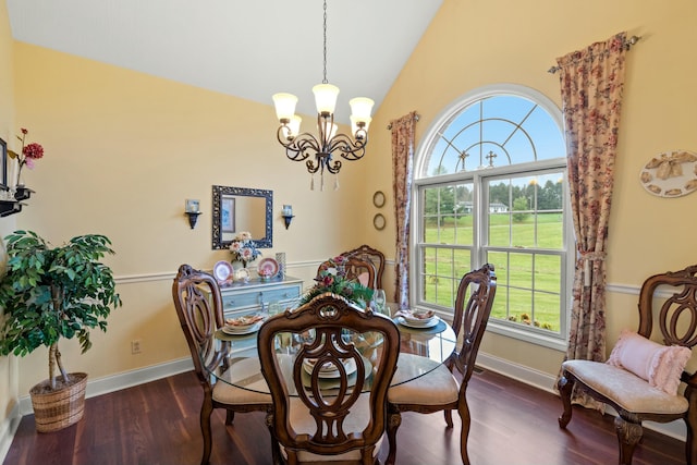 dining room featuring dark hardwood / wood-style flooring, a healthy amount of sunlight, and vaulted ceiling