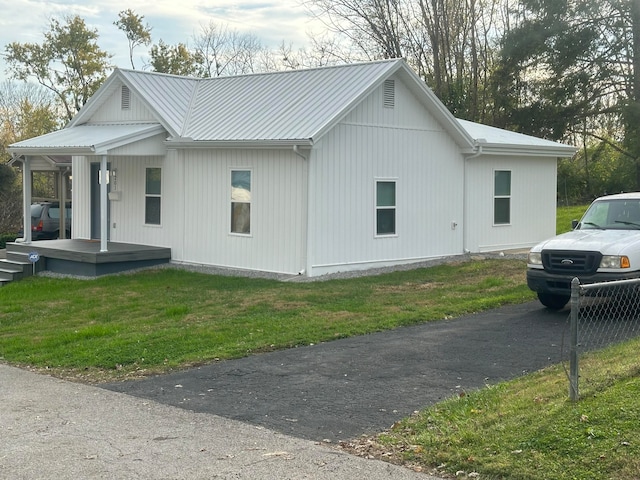 view of side of property with a lawn and a porch