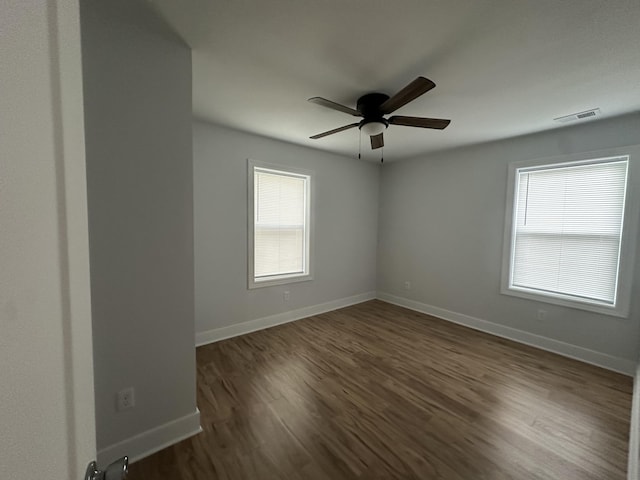 spare room with ceiling fan and dark wood-type flooring