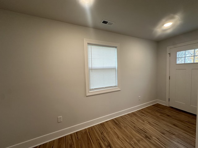 unfurnished room featuring dark wood-type flooring