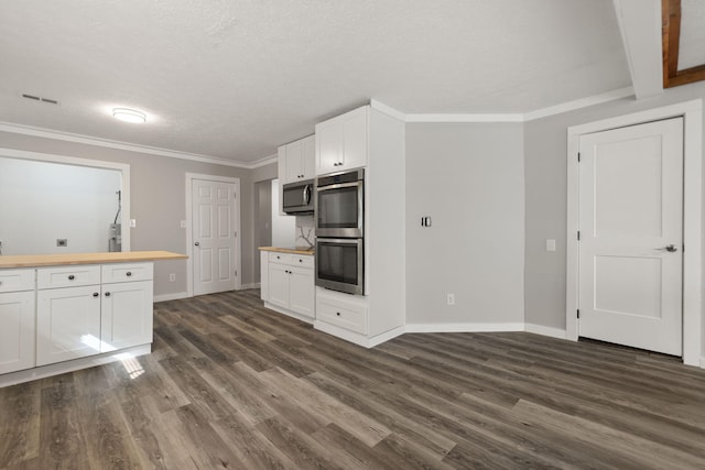 kitchen with white cabinetry, dark wood-type flooring, wooden counters, a textured ceiling, and appliances with stainless steel finishes