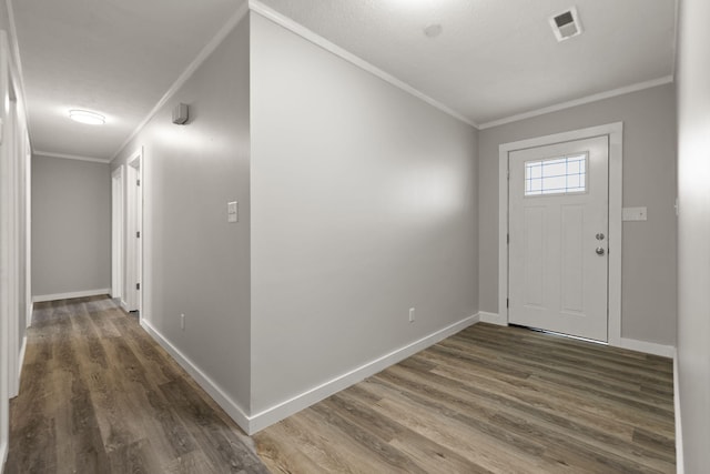 foyer featuring crown molding and dark hardwood / wood-style floors