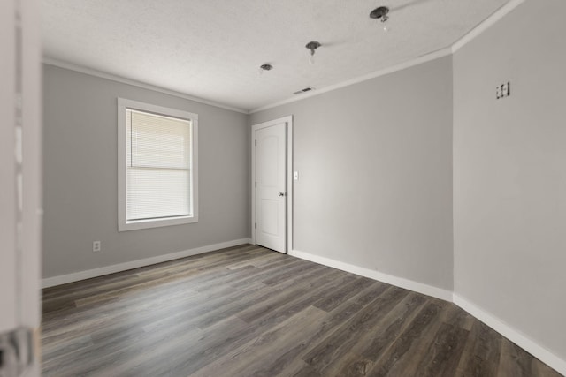 spare room featuring hardwood / wood-style floors, crown molding, and a textured ceiling