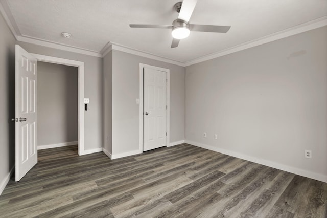 unfurnished bedroom featuring ceiling fan, ornamental molding, and dark wood-type flooring