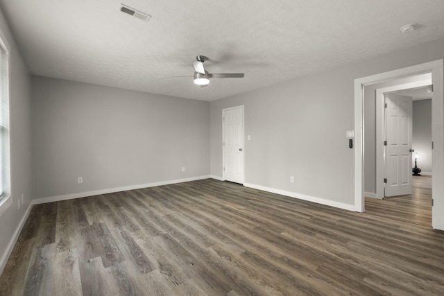 unfurnished room featuring a textured ceiling, ceiling fan, and dark hardwood / wood-style floors