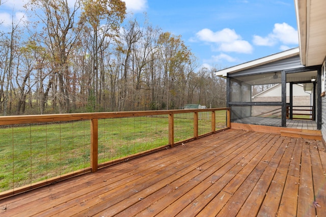 wooden deck with a sunroom and a lawn