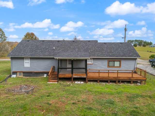 rear view of property with a yard and a deck