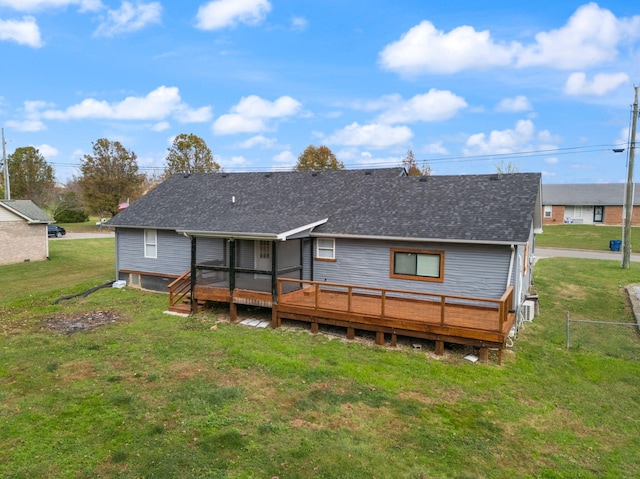 back of property with a lawn and a deck