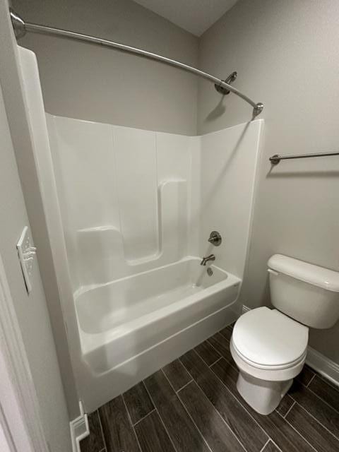 bathroom featuring toilet and tub / shower combination