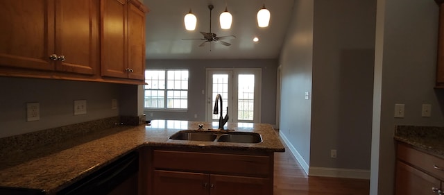 kitchen featuring dishwasher, sink, vaulted ceiling, ceiling fan, and kitchen peninsula