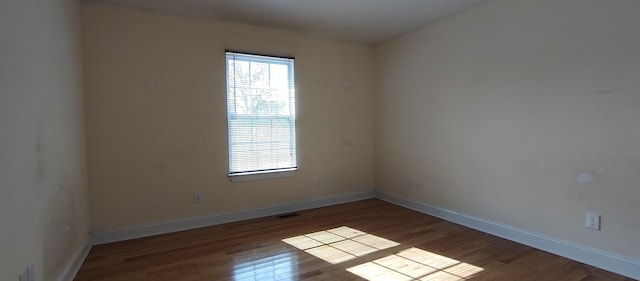 empty room with wood-type flooring