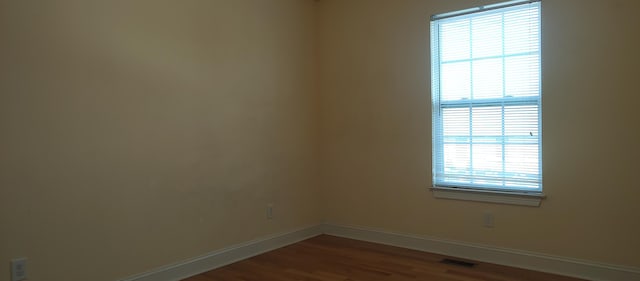 unfurnished room featuring hardwood / wood-style floors