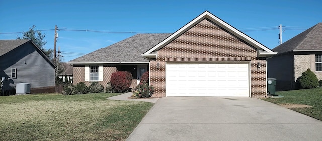 view of front of property featuring central AC unit, a garage, and a front yard