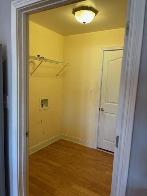 laundry room with hardwood / wood-style floors and washer hookup