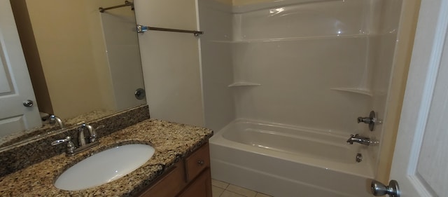 bathroom with tile patterned floors, vanity, and  shower combination