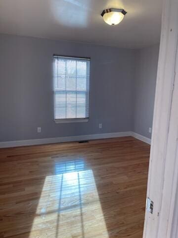 empty room with wood-type flooring