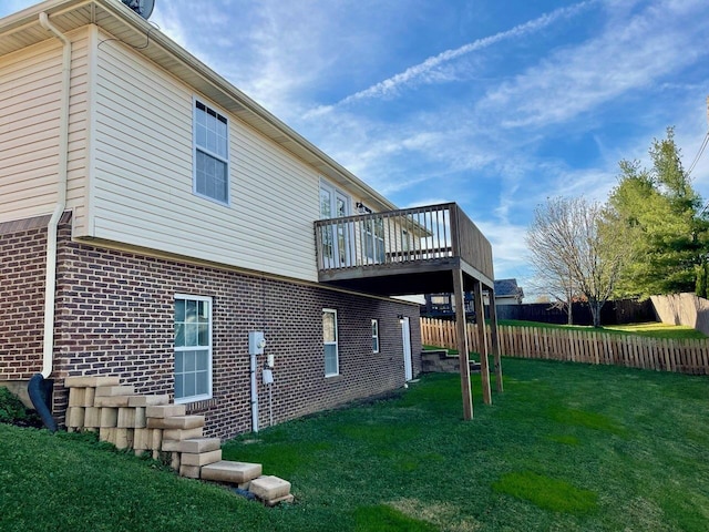 view of home's exterior with a deck and a yard