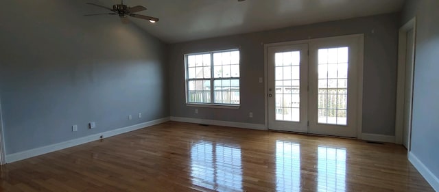 unfurnished room with hardwood / wood-style flooring, plenty of natural light, and ceiling fan