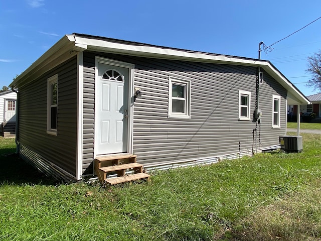 view of home's exterior featuring a lawn and cooling unit