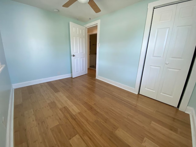 unfurnished bedroom featuring a closet, light hardwood / wood-style flooring, and ceiling fan