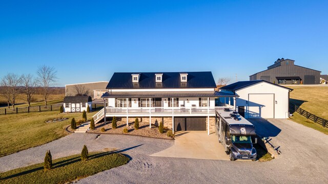 view of front of house with solar panels, a yard, covered porch, and a garage