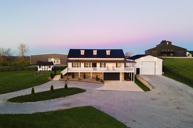 view of front of home featuring a garage, a balcony, and covered porch