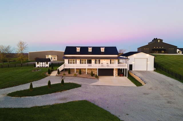 view of front facade featuring an outdoor structure, stairs, stone siding, driveway, and a front yard