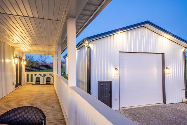 deck at dusk featuring covered porch