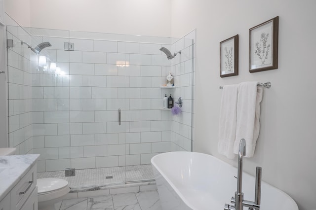 bathroom with marble finish floor, toilet, a freestanding tub, and a stall shower