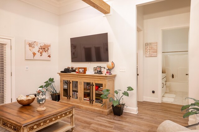 living room with crown molding, hardwood / wood-style floors, a chandelier, french doors, and beamed ceiling