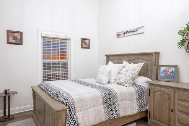 bedroom featuring baseboards and wood finished floors