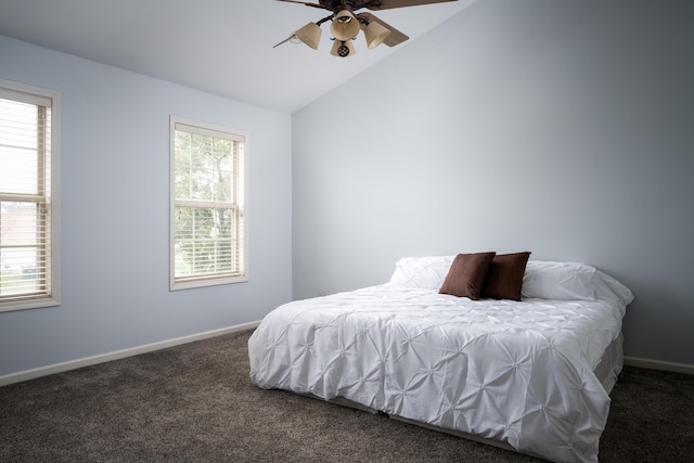 carpeted bedroom with ceiling fan and vaulted ceiling