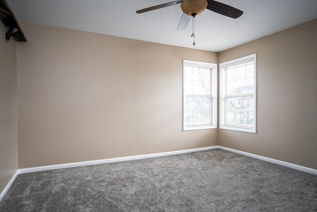 carpeted spare room with ceiling fan