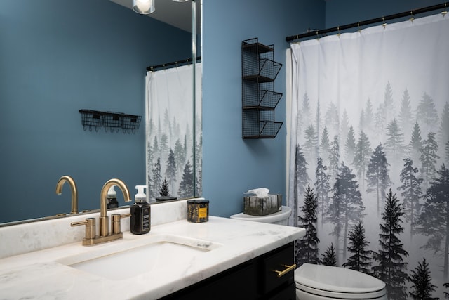 bathroom featuring vanity, toilet, and curtained shower