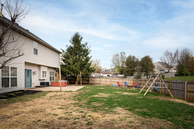 view of yard featuring central AC and a patio