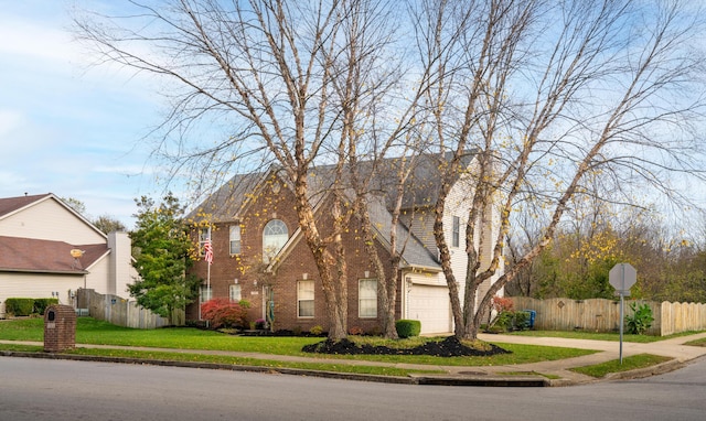 view of front of property featuring a front yard and a garage