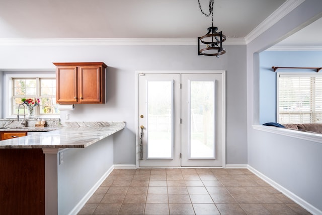 entryway featuring light tile patterned flooring, crown molding, sink, and an inviting chandelier