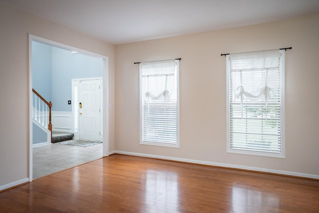 spare room featuring a healthy amount of sunlight and light hardwood / wood-style flooring