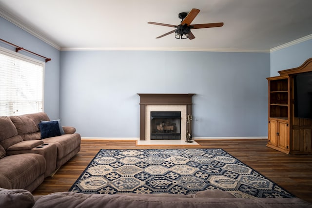 living room with ornamental molding, ceiling fan, and dark wood-type flooring