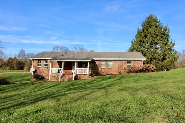 view of front of house featuring covered porch and a front yard