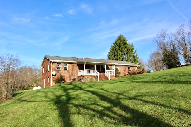 ranch-style house with covered porch and a front yard