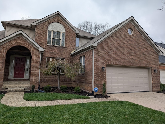 front of property featuring a front yard and a garage